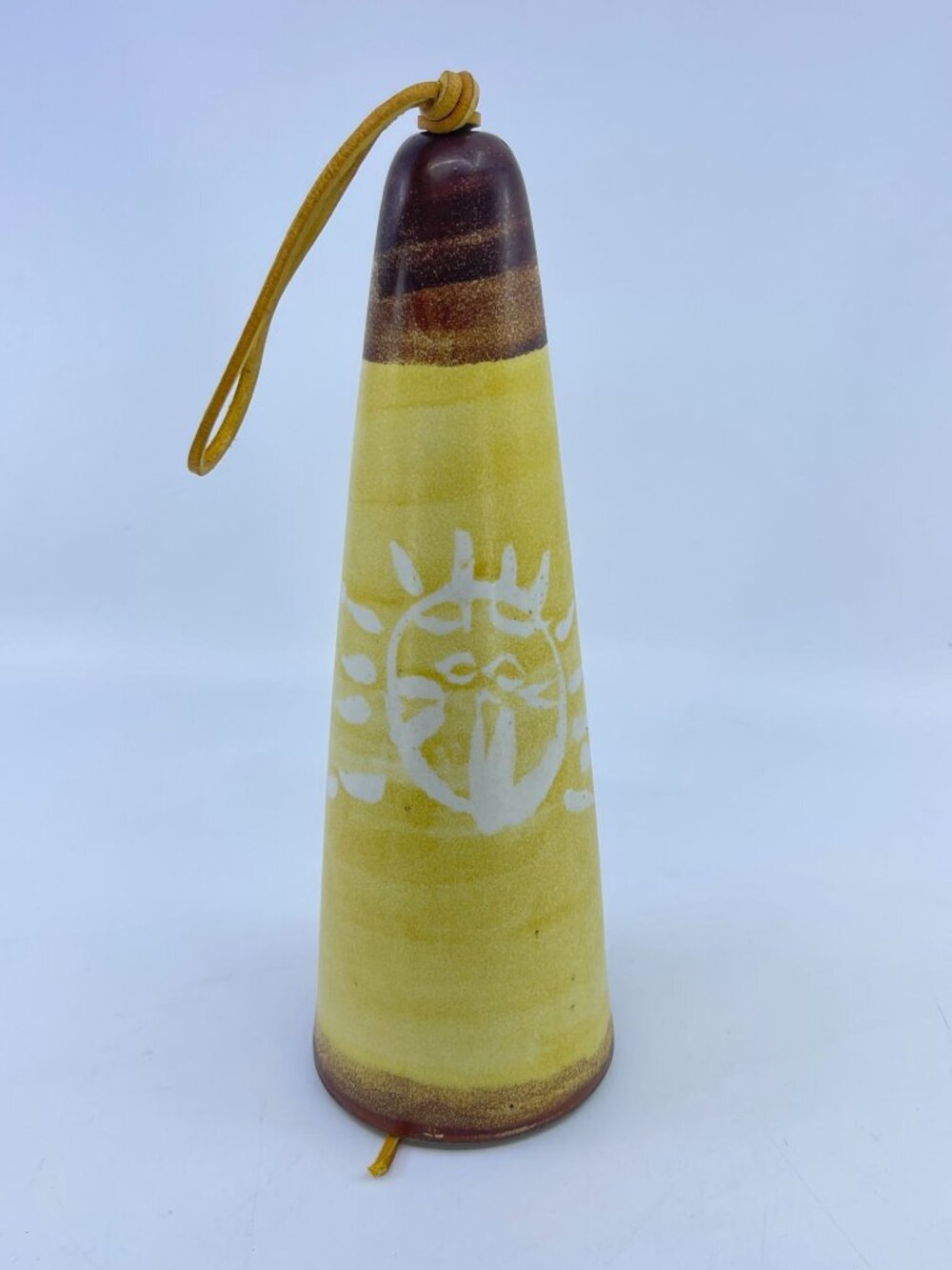 vintage wind bell by pacific stoneware with sun motif & leather cord